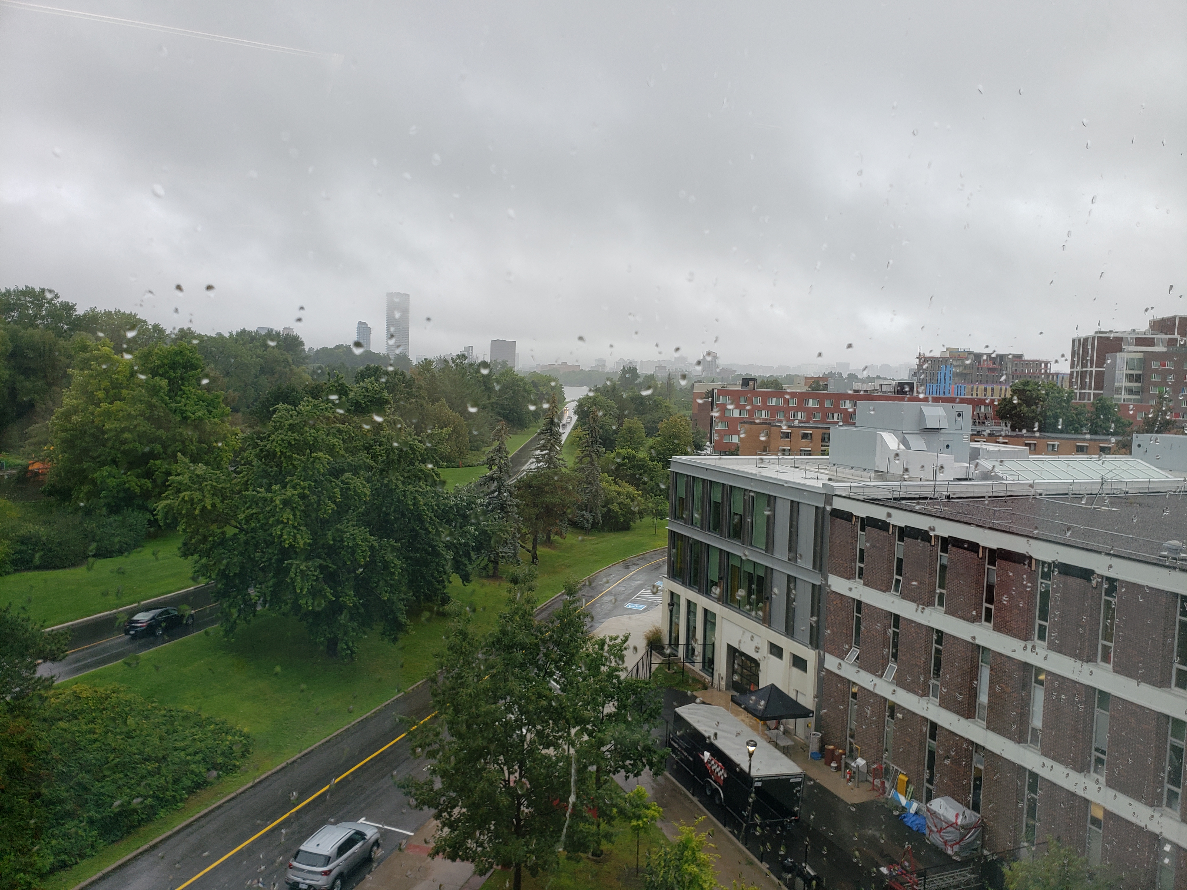 A foggy rainy view of the Rideau Canal, Colonel By Drive, and Library Road as viewed from the Carleton University campus.