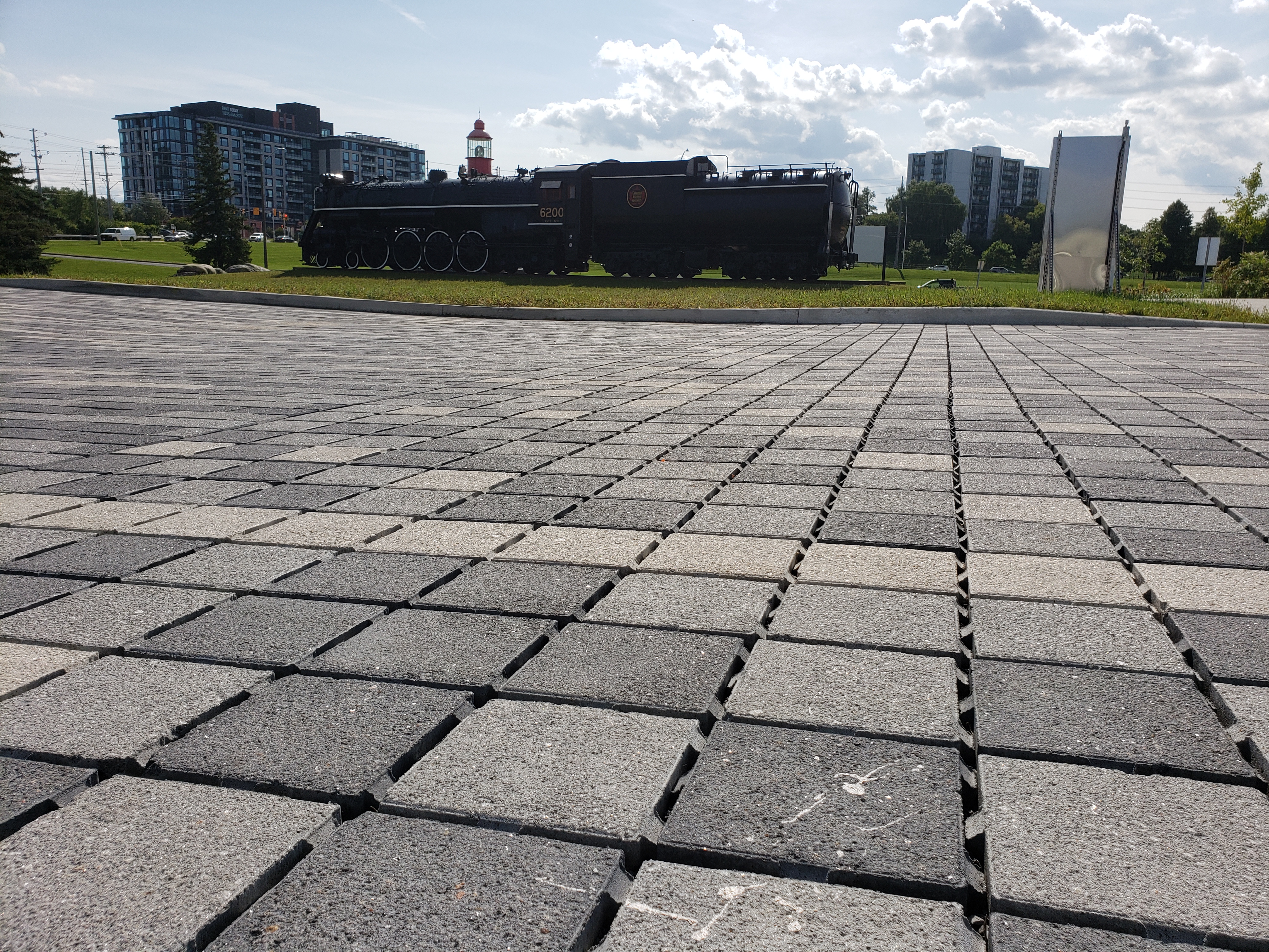 A network of permeable grey and black asphalt blocks, comprising a parking lot.
